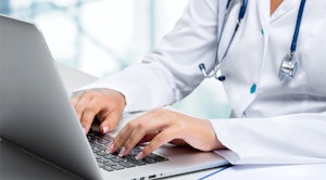 medical worker typing on laptop