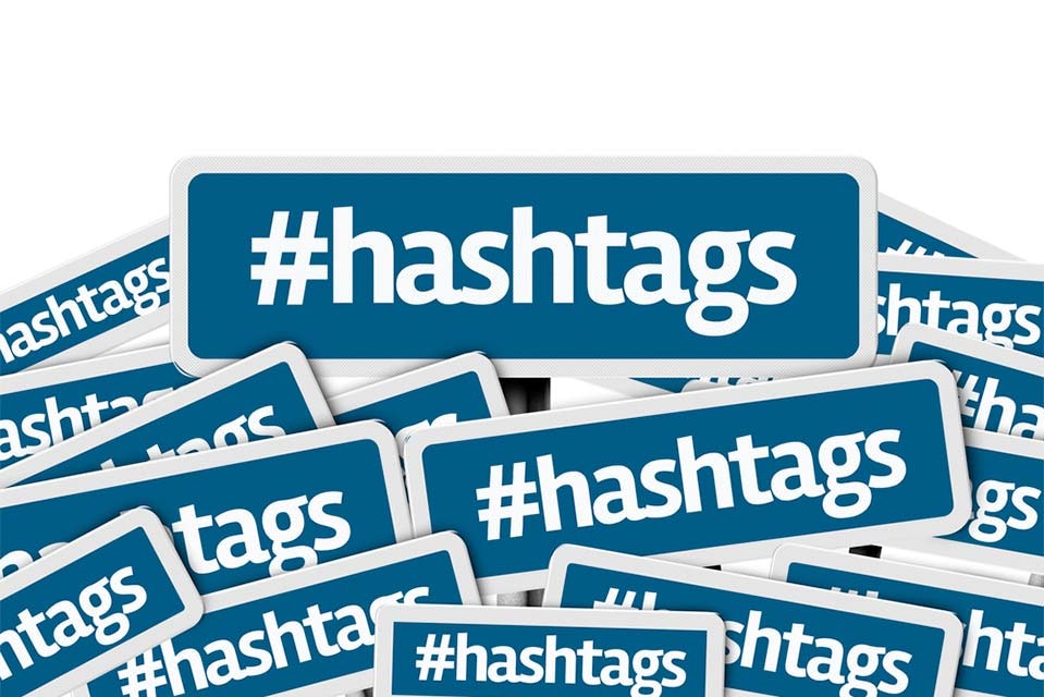 Hashtags written on multiple blue road sign