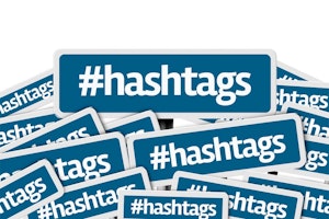Hashtags written on multiple blue road sign