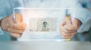 Patient hand holding digital smart tablet visual interface