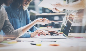 Marketers meeting in front of a laptop