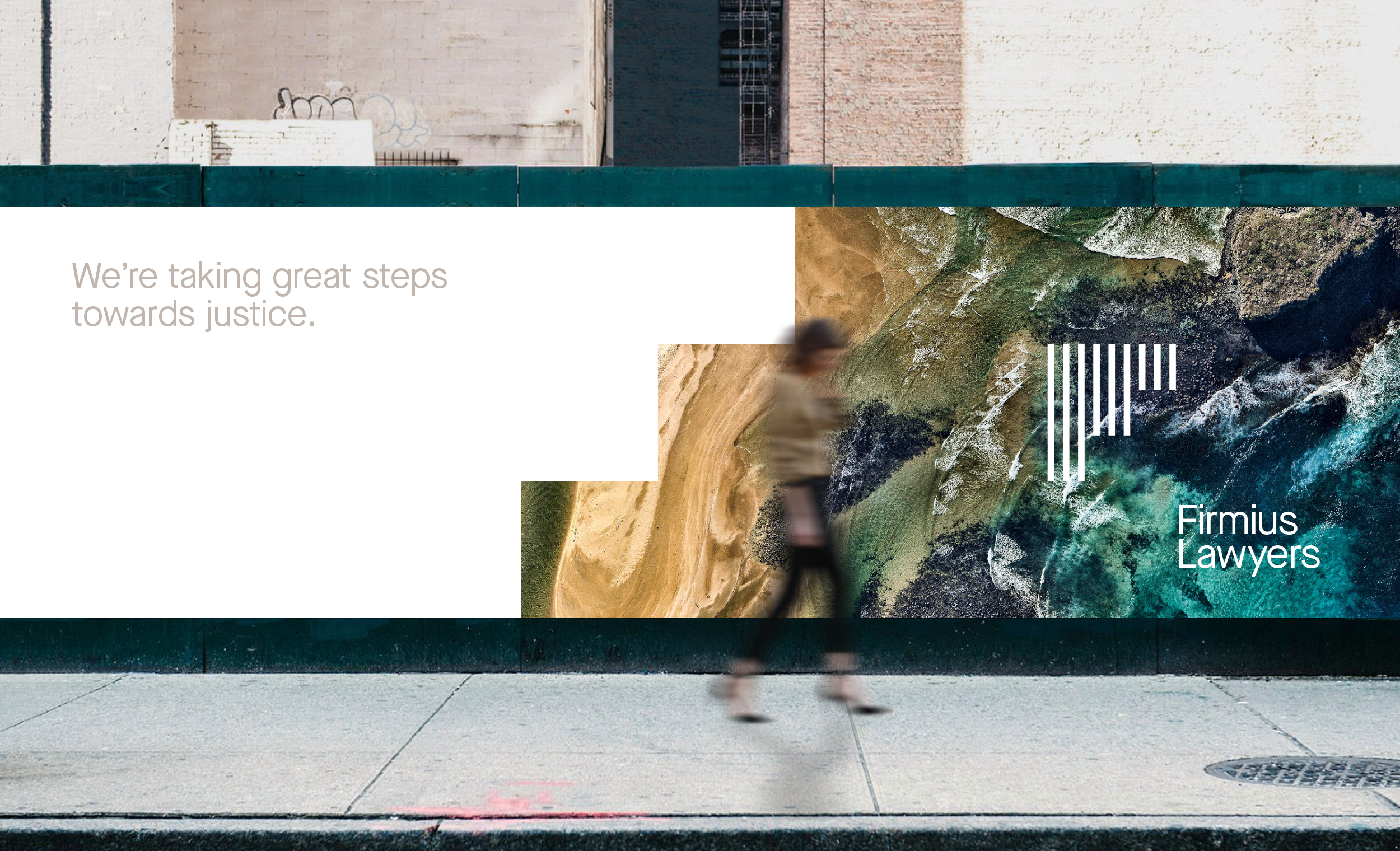 A person walks along the sidewalk along a Firmius billboard