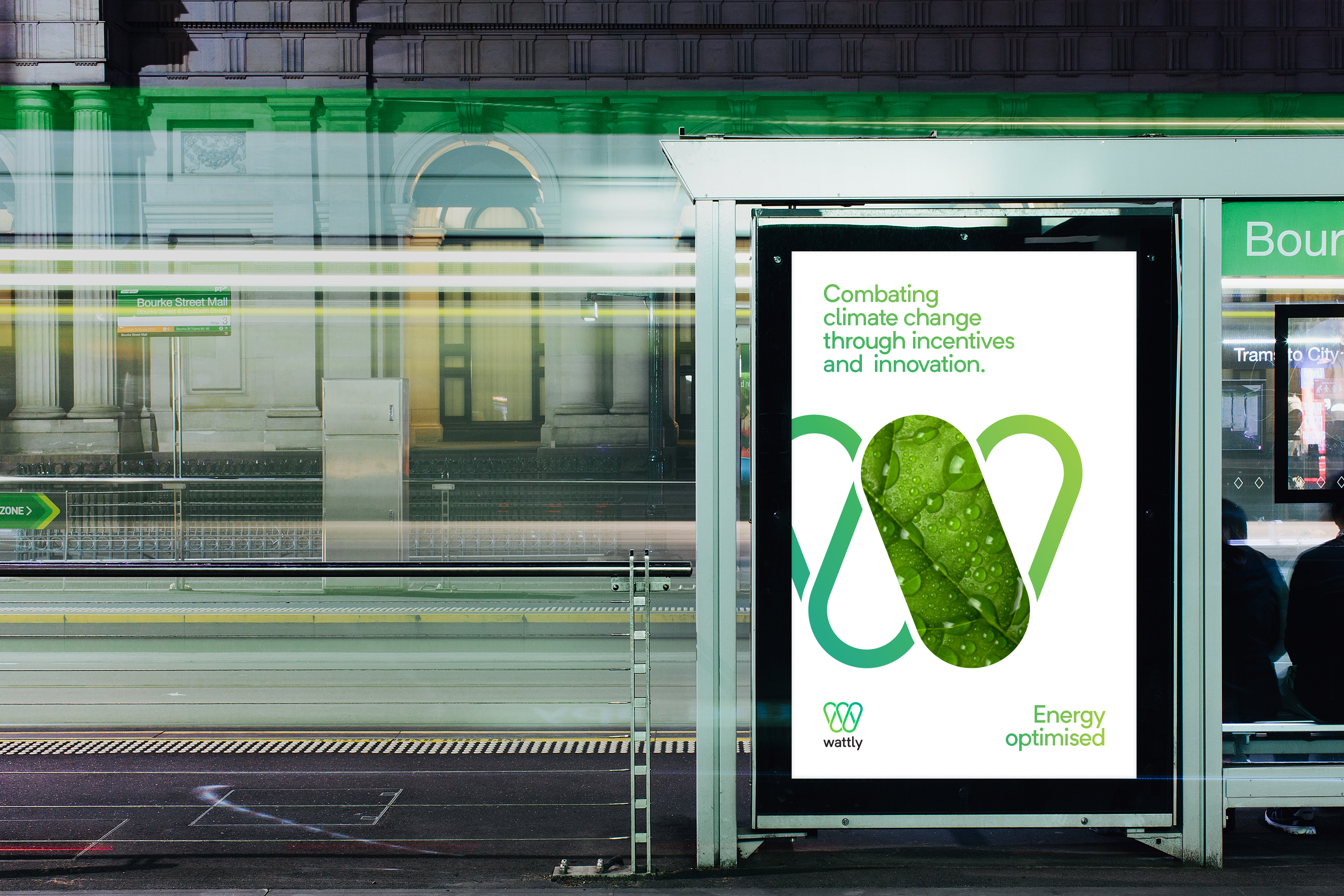 A Melbourne City tram stop with a digital billboard featuring Wattly