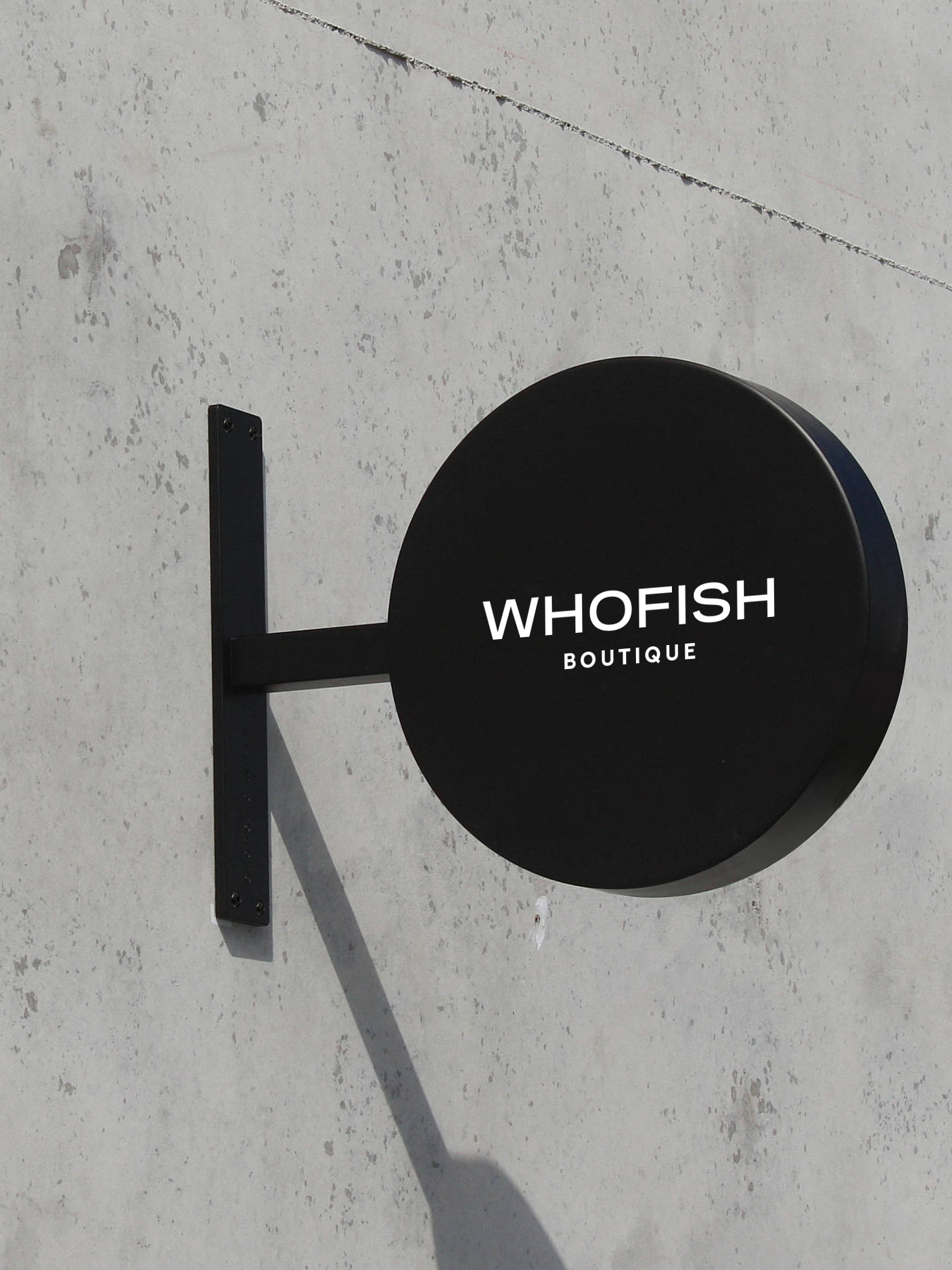 A round black store sign