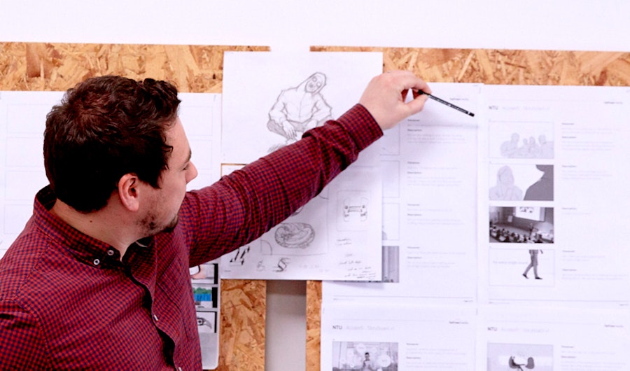 an image of Neil Rostance working on an animation storyboard