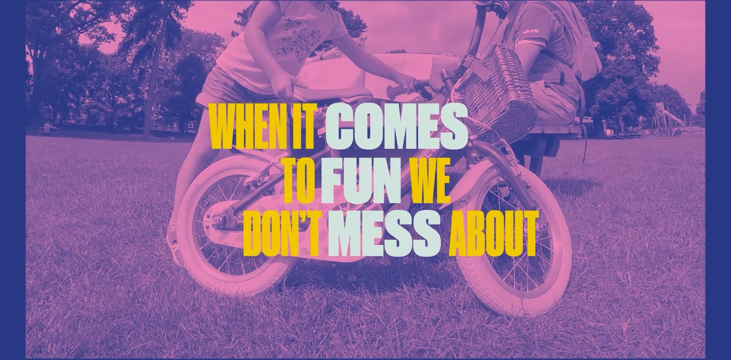 Image of a bike being leaned against a picnic table in a park by a child. The image is tinted pink and blue, and text overlaid reads "When it comes to fun, we don't mess about"