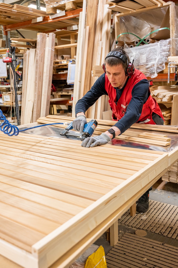 Worker working on sauna benches at the Harvia sauna factory