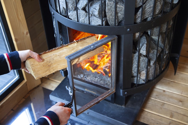 Adding wood to the Harvia Legend GreenFlame heater