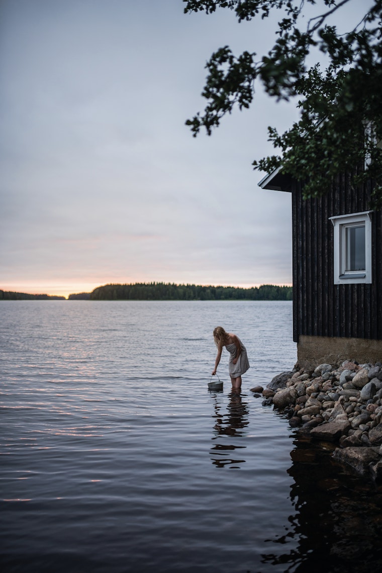 Woman fetching water from the lake