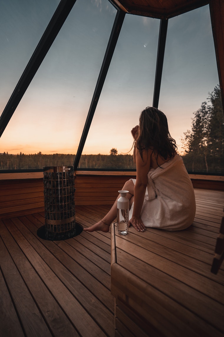 Woman watching sky while being in igloo sauna