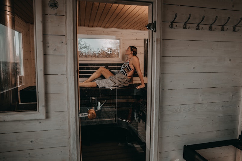 woman in sauna enjoying the steam