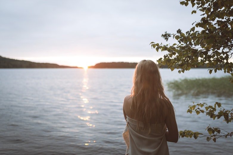 woman watching sunset in nature