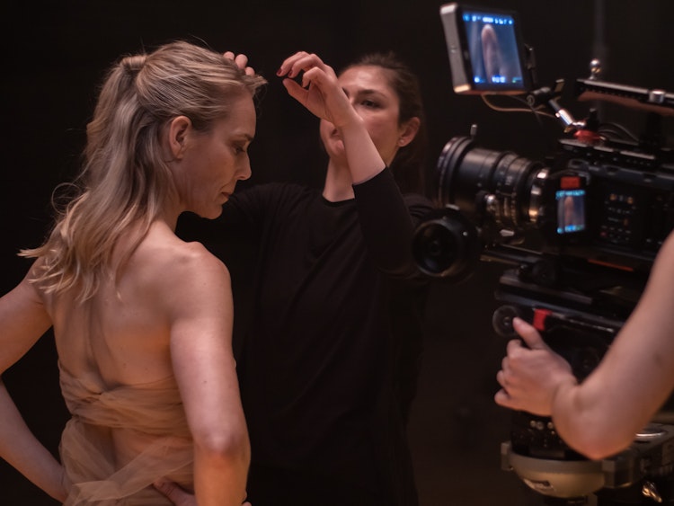 woman preparing performers hair during video-shoot