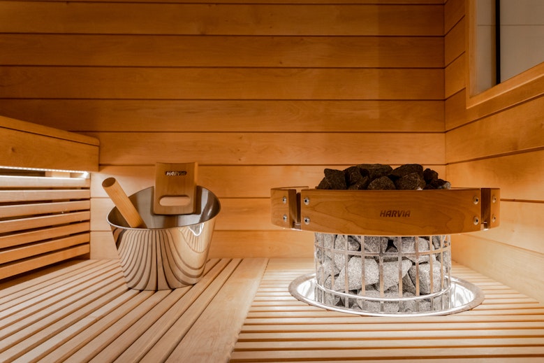 close up picture of sauna heater and bucket