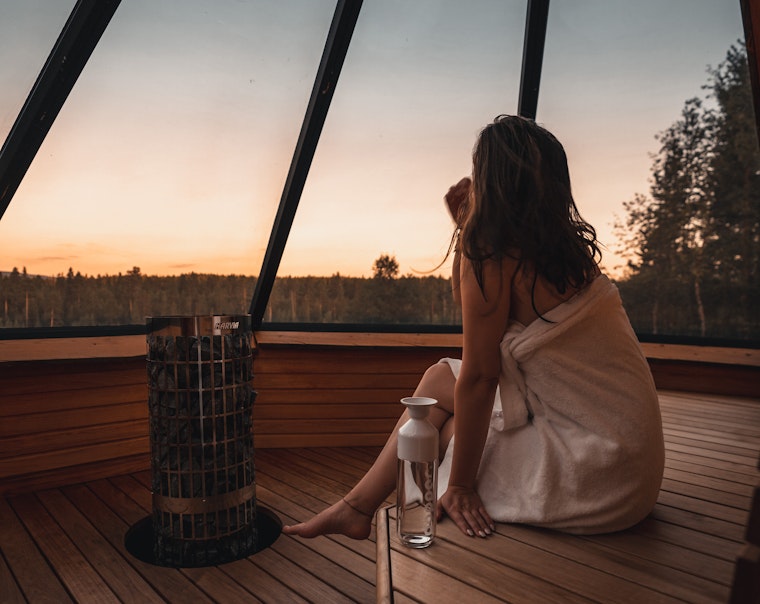 woman watching sky while being in igloo sauna