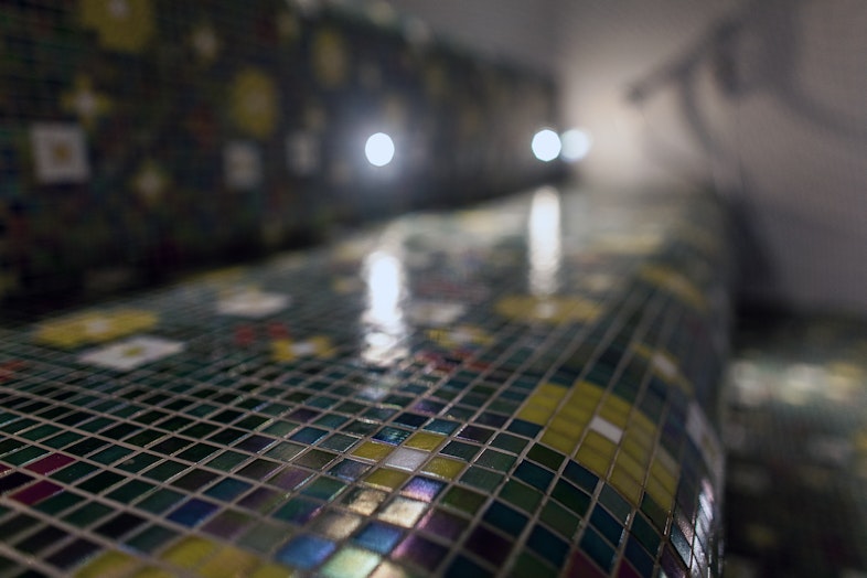 Close-up picture of tiles laid on steam room bench