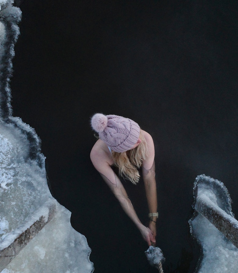 Lady winter swimming wearing hat