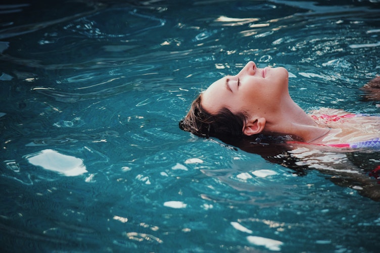 Woman smiling whilst bathing in water