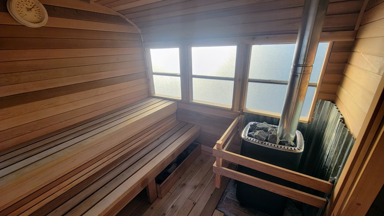 The crown of Sauna Social's school bus sauna is a Harvia M3 wood-burning heater