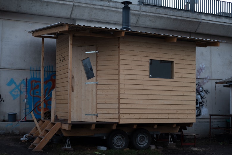 A sauna building, with wooden frame and wheels underneath.