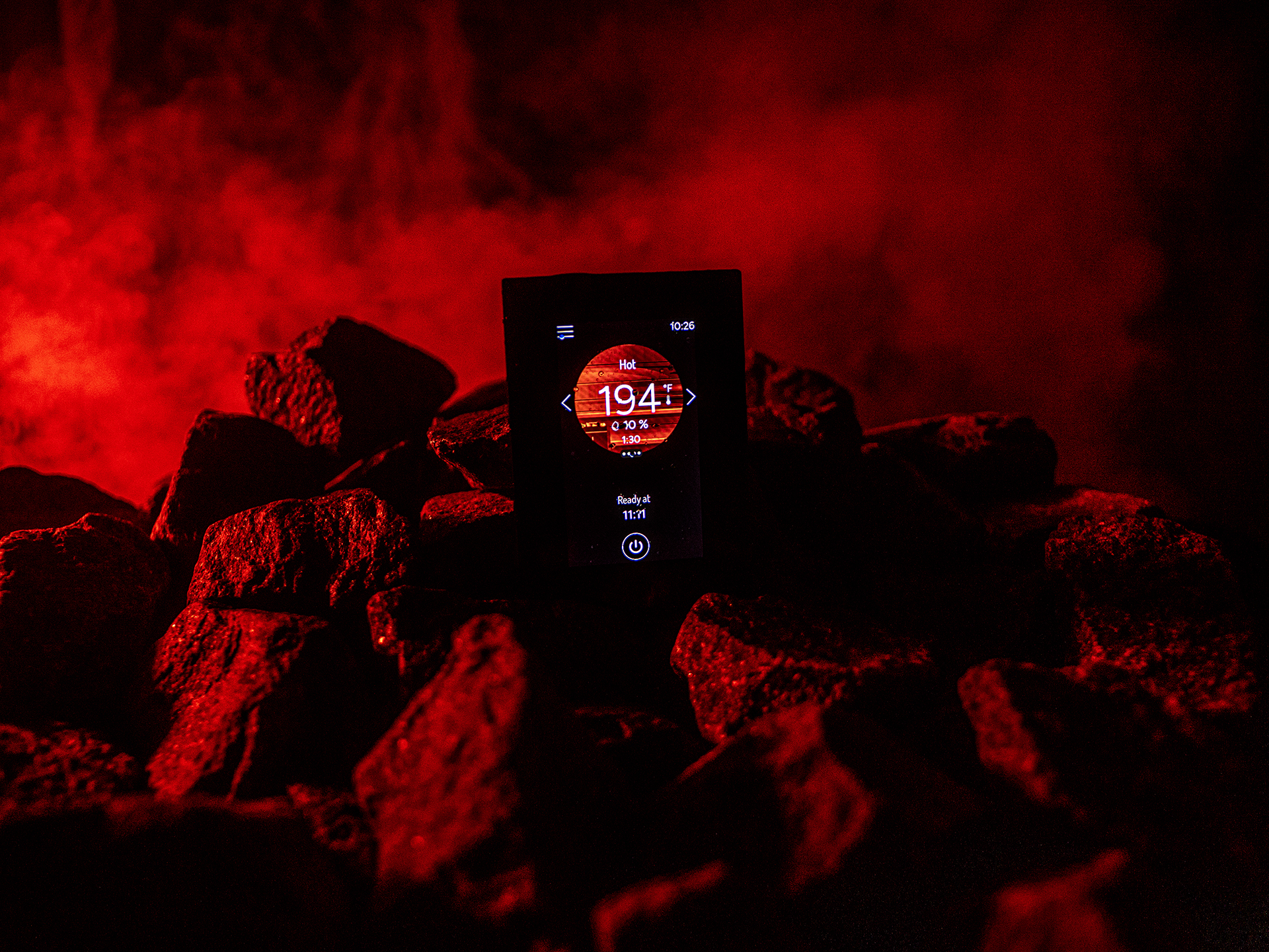 Harvia Fenix sauna control panel mounted on wall with illuminated 4.3 inch glass touchscreen