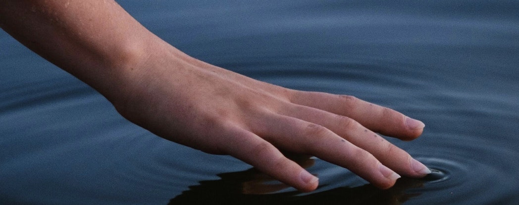 hand touching water