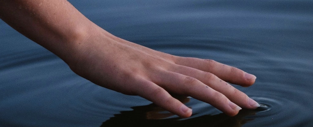 hand touching water