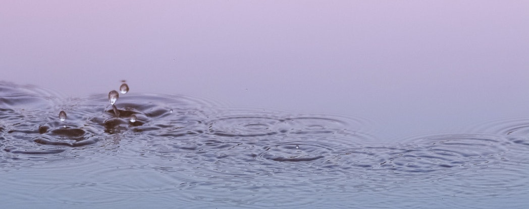 water droplets falling into a pond