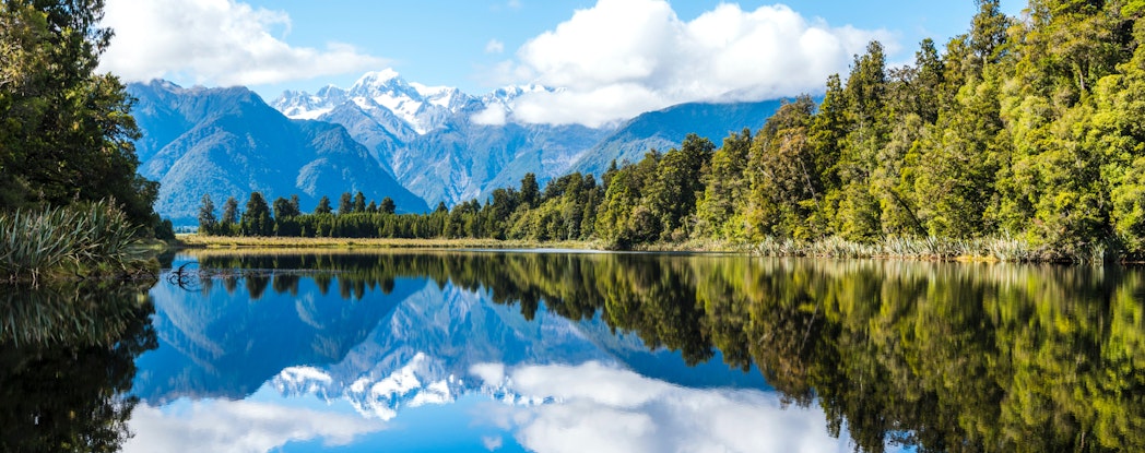 lake by the forest and mountains