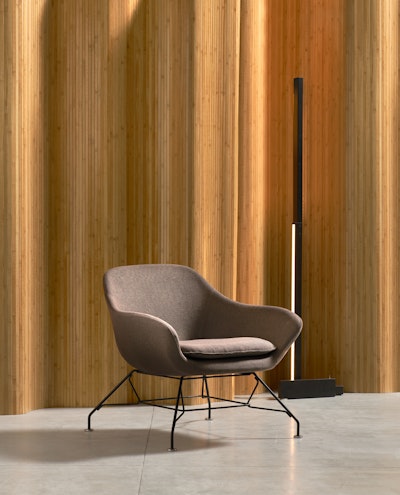 Manta armchair positioned near a curtain in a hall