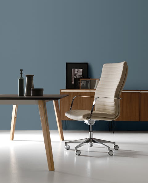 Aurora 2.0 armchair comfort and aesthetics Aurora armchair in front of a table in a dining room