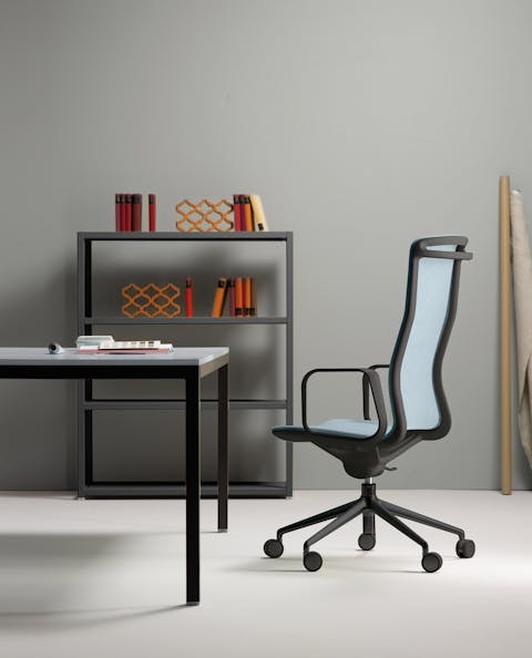 Less chair with a refined design and soft shapes Example of placing the Less armchair in the office