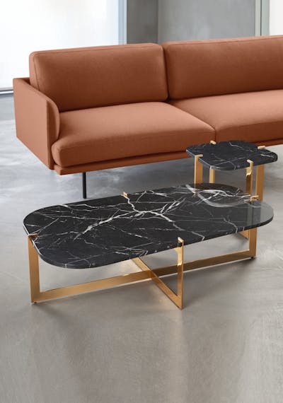 Cruz coffee tables in different sizes placed next to the sofa