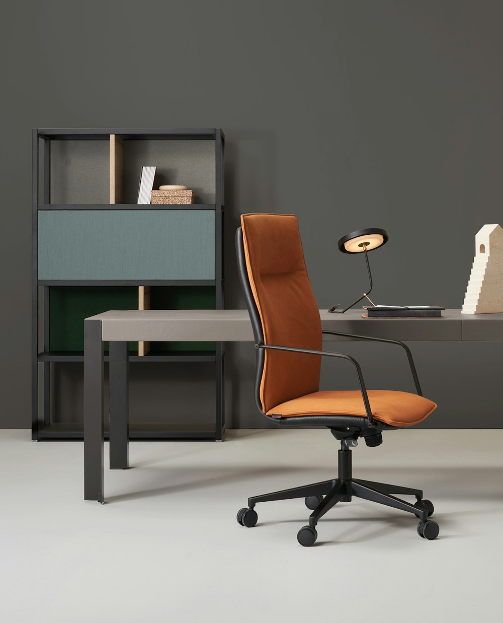 Maybe essential seat with classic lines Maybe armchair positioned laterally in an office near the desk