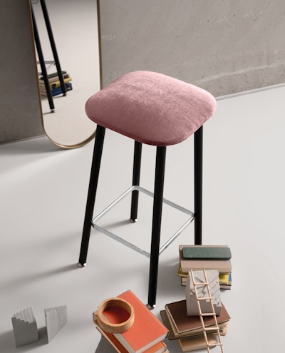 Bista stool in front of a mirror with room accessories