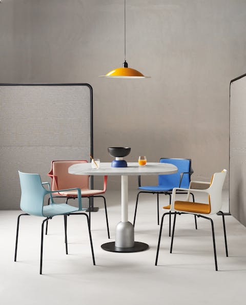 Kelly seat has a material and performance aspect Kelly seats arranged in a room around a round table