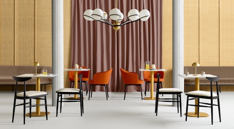 Morbide poltroncine da hotel e ristorazione Arwa La foto di una sala lounge di un ristorante con in fondo poltroncine Arwa.