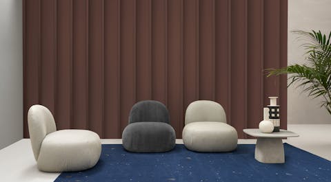 Poltrona Hill con forma retrò e design minimale Poltrone Hill disposte in un salotto con un tavolino e un tappeto