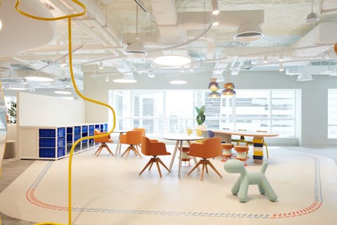 Colourful chairs and tables in a large light room