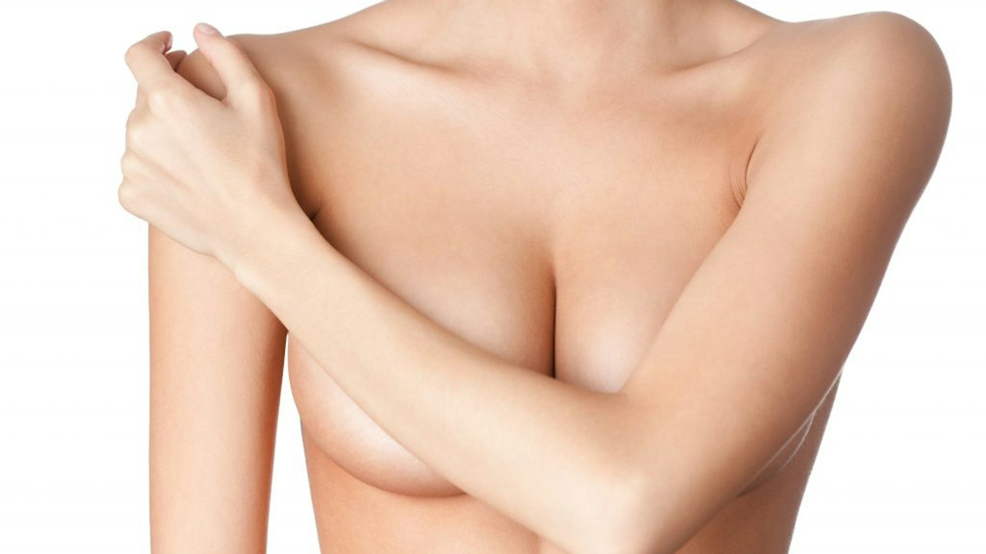 Woman with no top on covering her breasts
