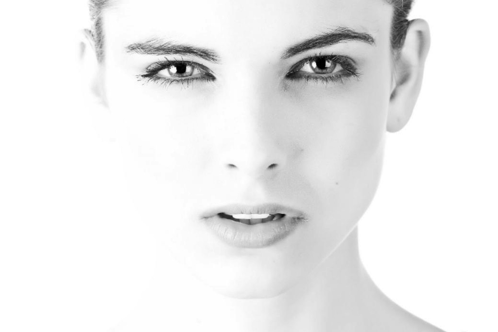 Young woman staring at camera with white background