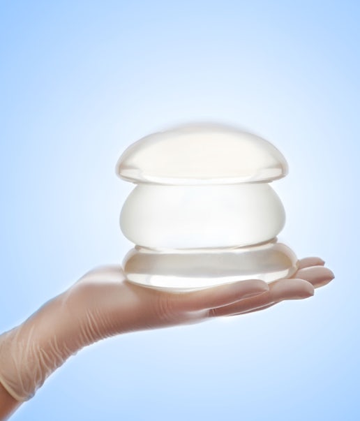 Breast implants being held on a hand
