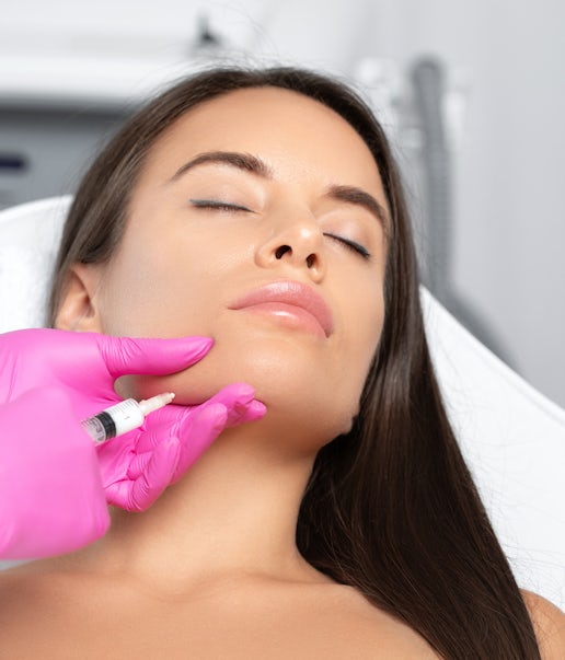 A woman's face being injected 