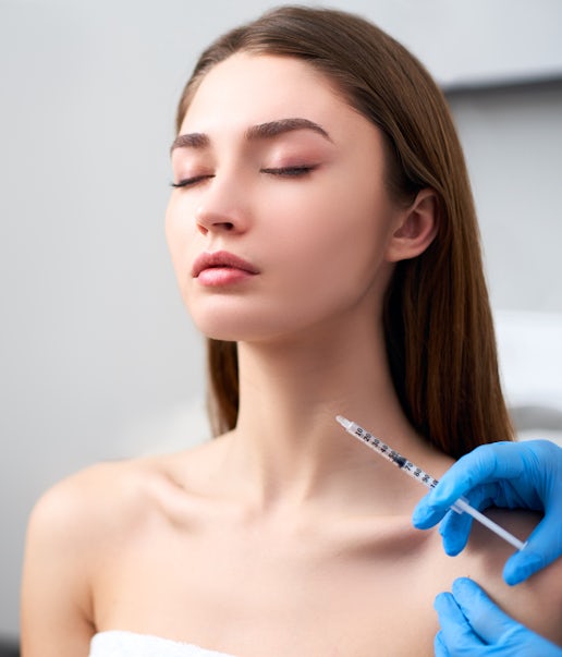 A woman's neck being injected