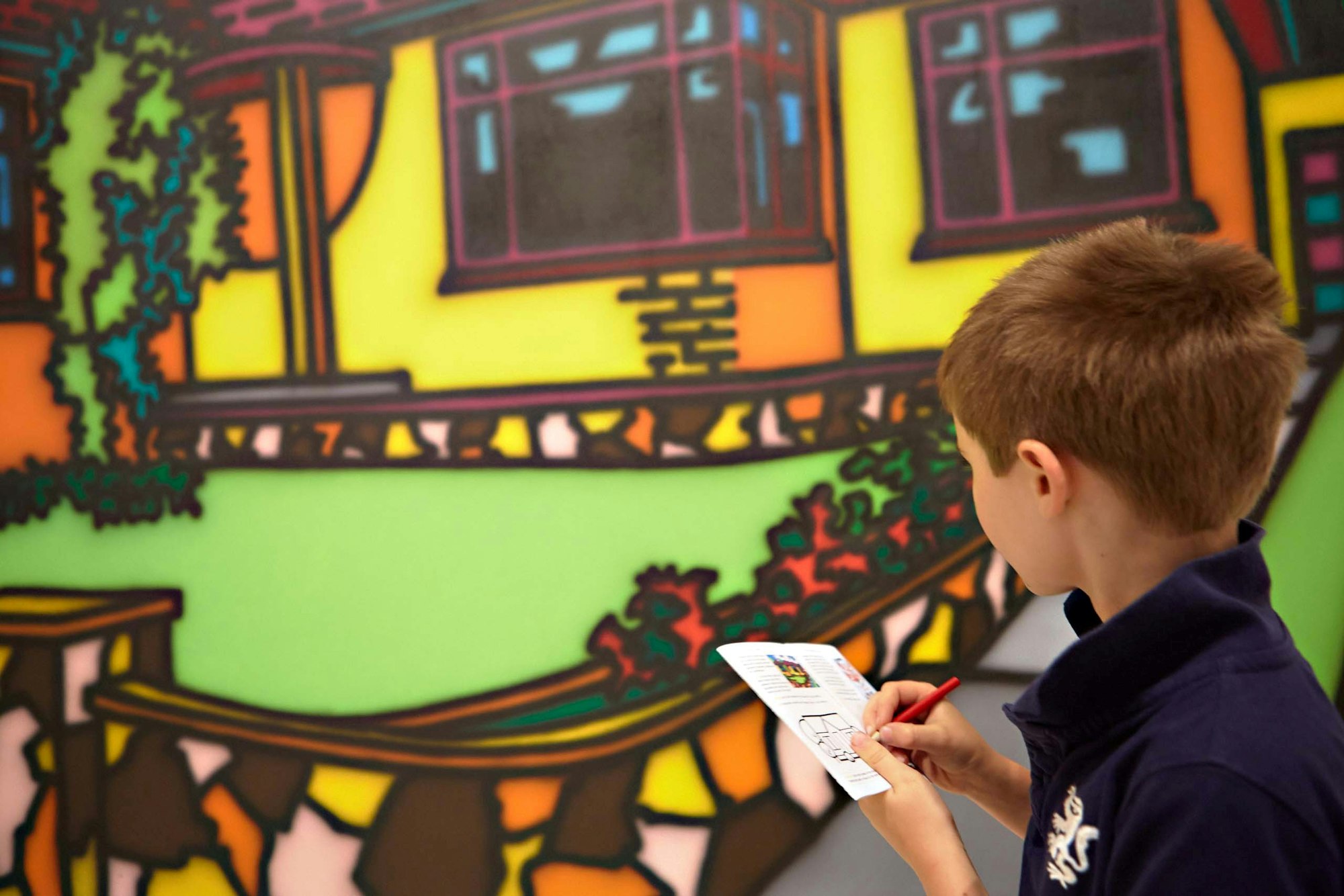 A young visitor with Howard Arkley’s 1987 painting Triple fronted, Art Gallery of New South Wales © The Estate of Howard Arkley, courtesy Kalli Rolfe Contemporary Art