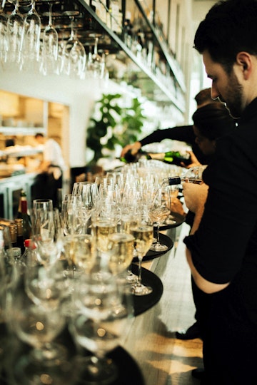Waiter pouring champagne for a function