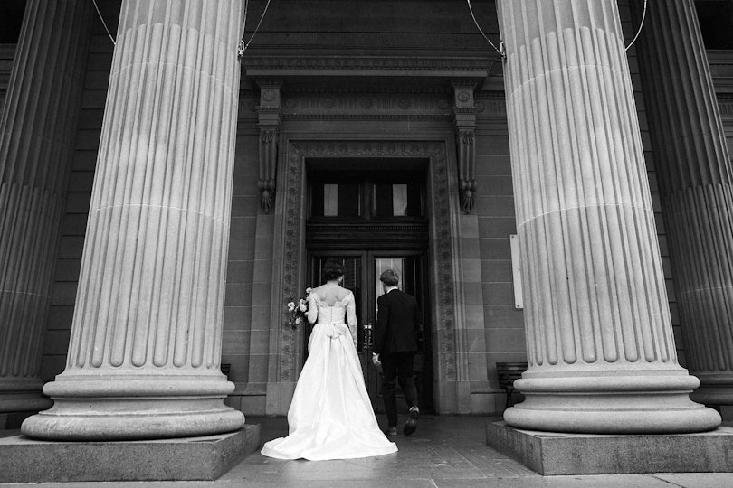Black and white photo of a bride and groom entering the Gallery