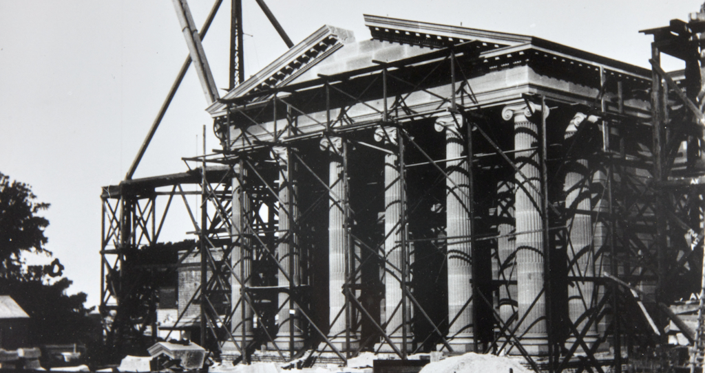 Historical exterior view of the final stone about to be placed in the pediment above the entrance portico of the Gallery from the Art Gallery of New South Wales Institutional Archive 24 March 1902 