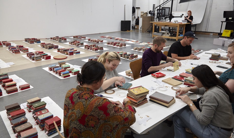 Assessing the condition and cataloguing a complex artwork requires teamwork. Paper conservator Sarah Bunn co-ordinates a group of staff and volunteers to check the 3000 notebooks that comprise AGNSW collection artwork Chinese Bible, 2009, Yang Zhichao.