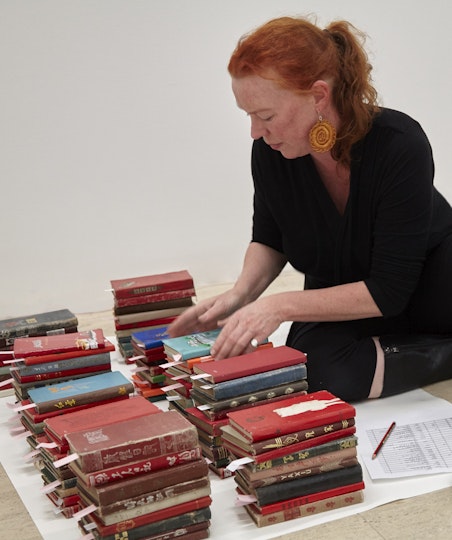 Paper conservator Sarah Bunn checks the condition and storage requirements for the 3000 note books that Chinese Bible, 2009, Yang Zhichao.